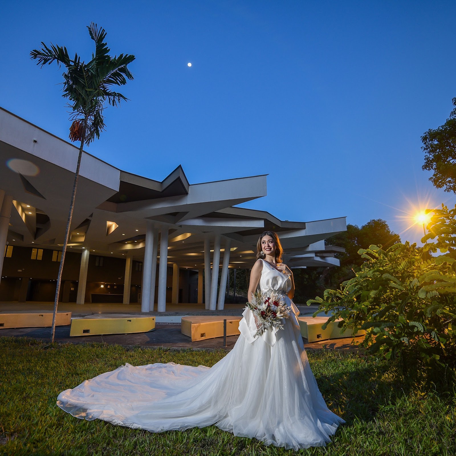 Bride standing in serene outdoor setting.